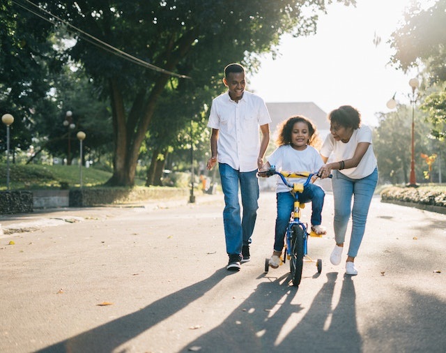 family with child riding bike