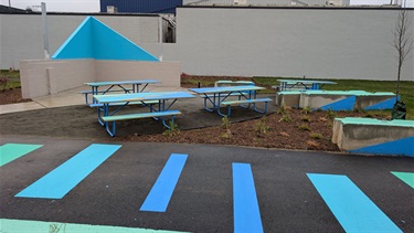 Recently painted Inner Ear Studio Memorial Wall and picnic tables - Nov. 26, 2025