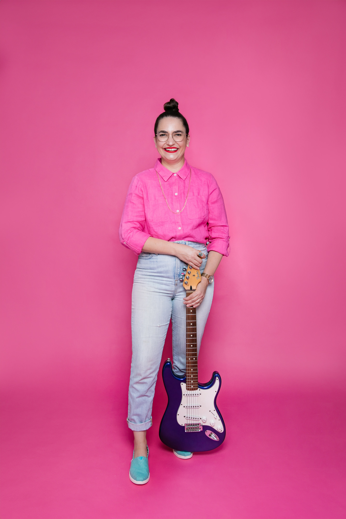 Mama Elena with electric guitar resting on the ground.