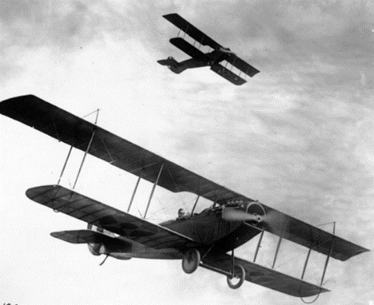 Photo of two curtiss JN-4D Jennys above a training camp in Texas around 1918