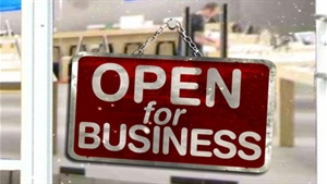 Photo of store sign that reads Open for business