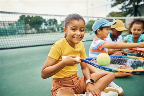 Tennis student, team exercise and training of a girl happy with children students. Portrait of a Indian child with a smile ready to start sports kids workout and fitness on a sport court