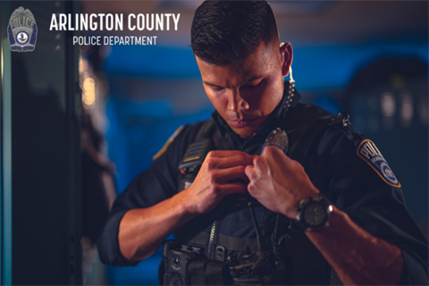 Officer pinning badge to uniform