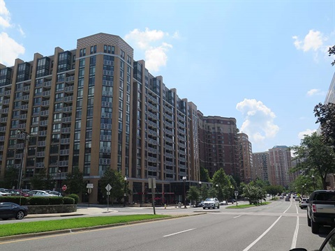street in the virginia square neighborhood with several large buildings