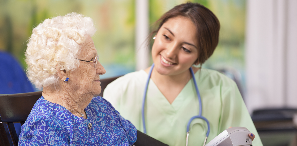 Nurse smiling at an older adult.