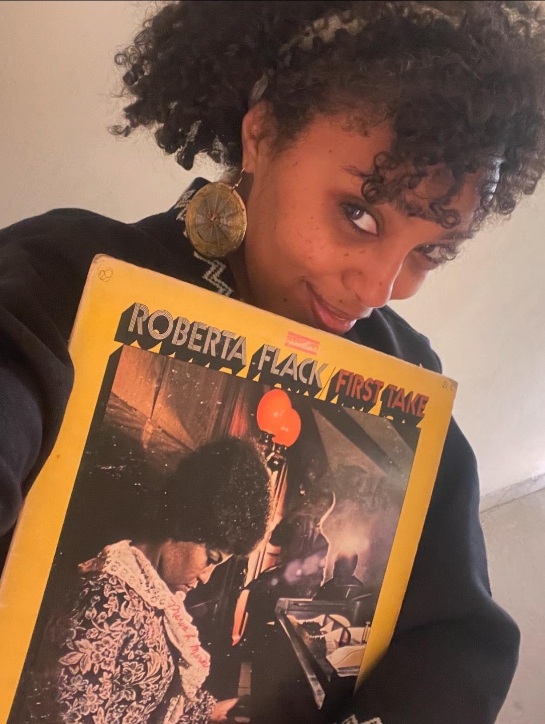 Munit Mesfin holding a Roberta Flack album
