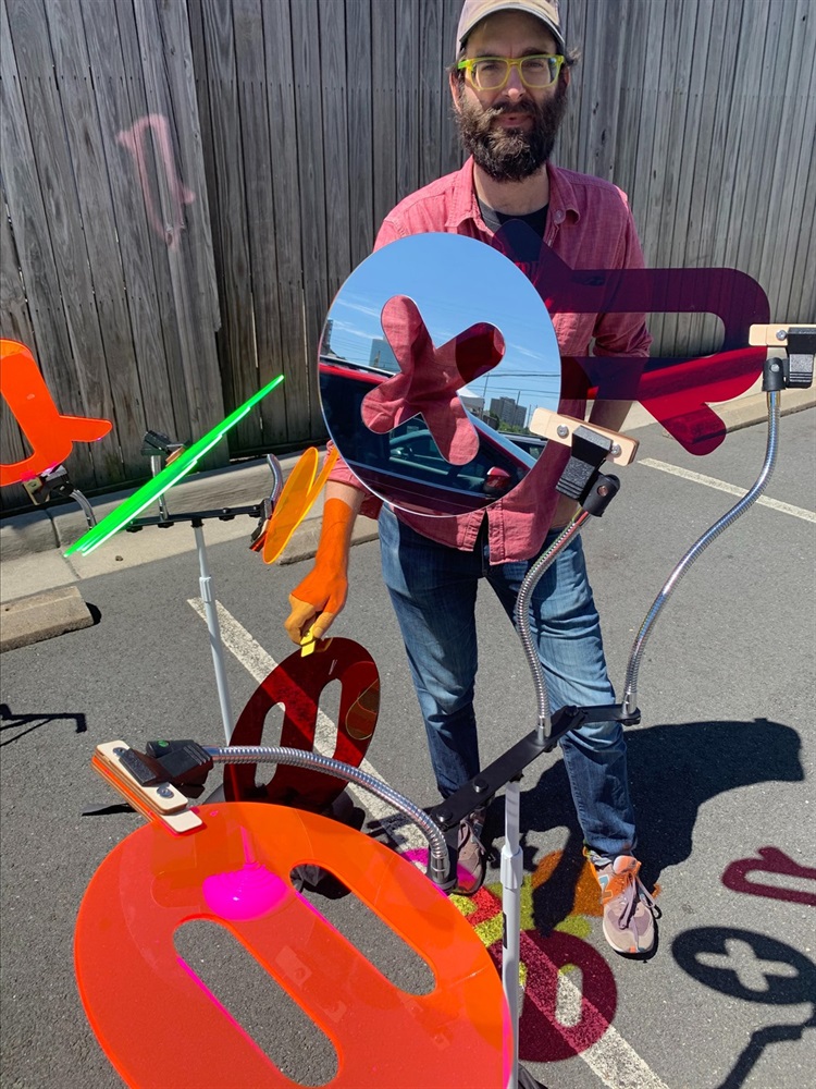 Tommy Bobo with the colored lenses and mirrors that make Chromatic Curiosity.jpg