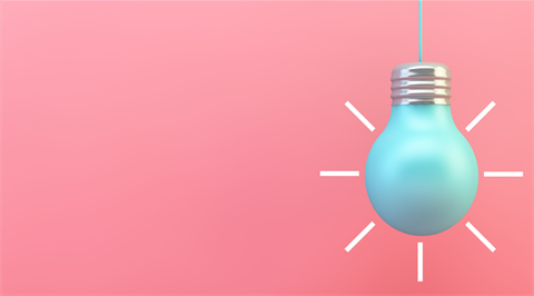 Dangling blue lightbulb in front of pink background.